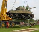 Sherman is lifted to its new location.